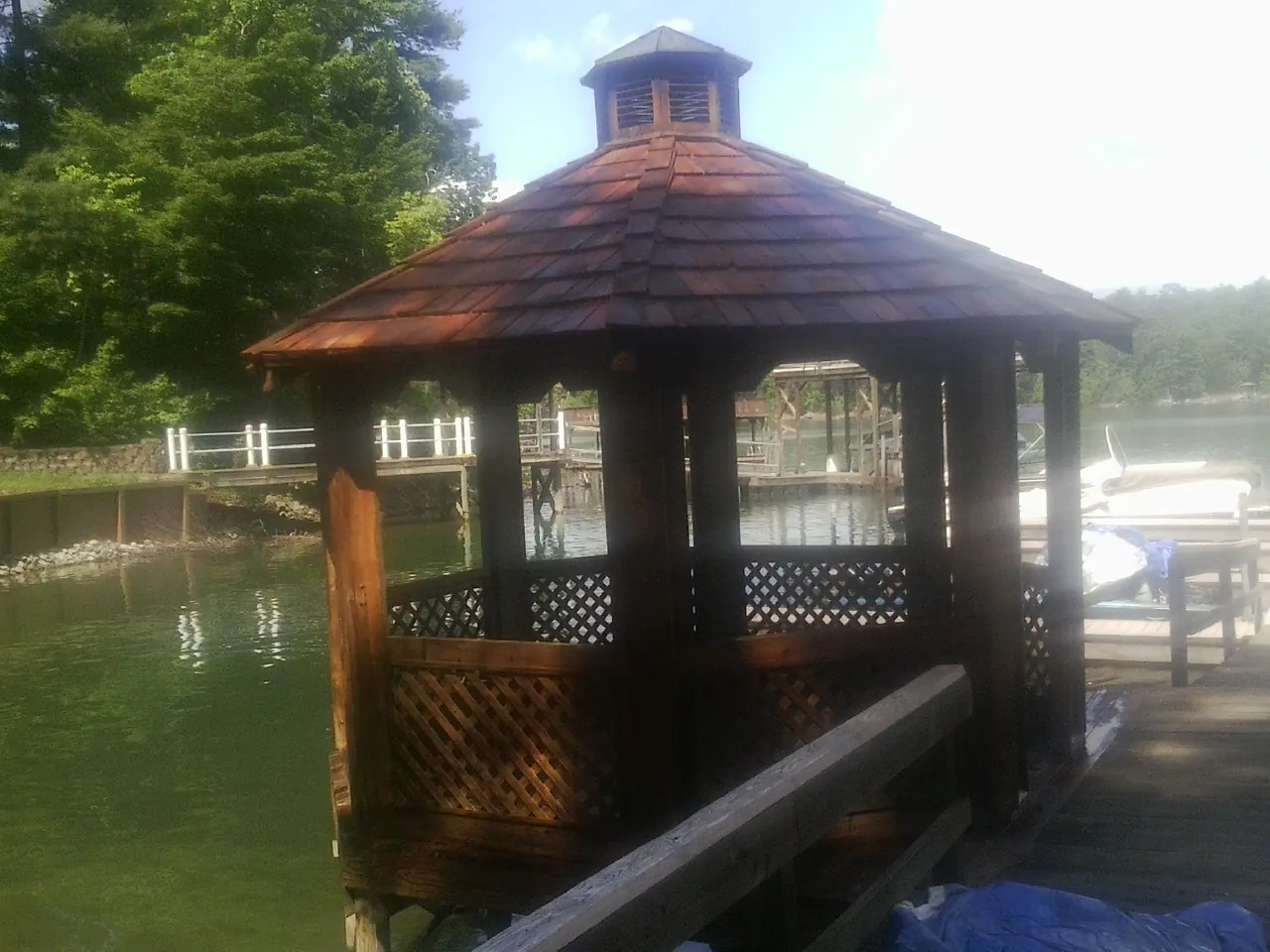 Cedar shake gazebo roof rebuilt on a lake dock in Sardinia